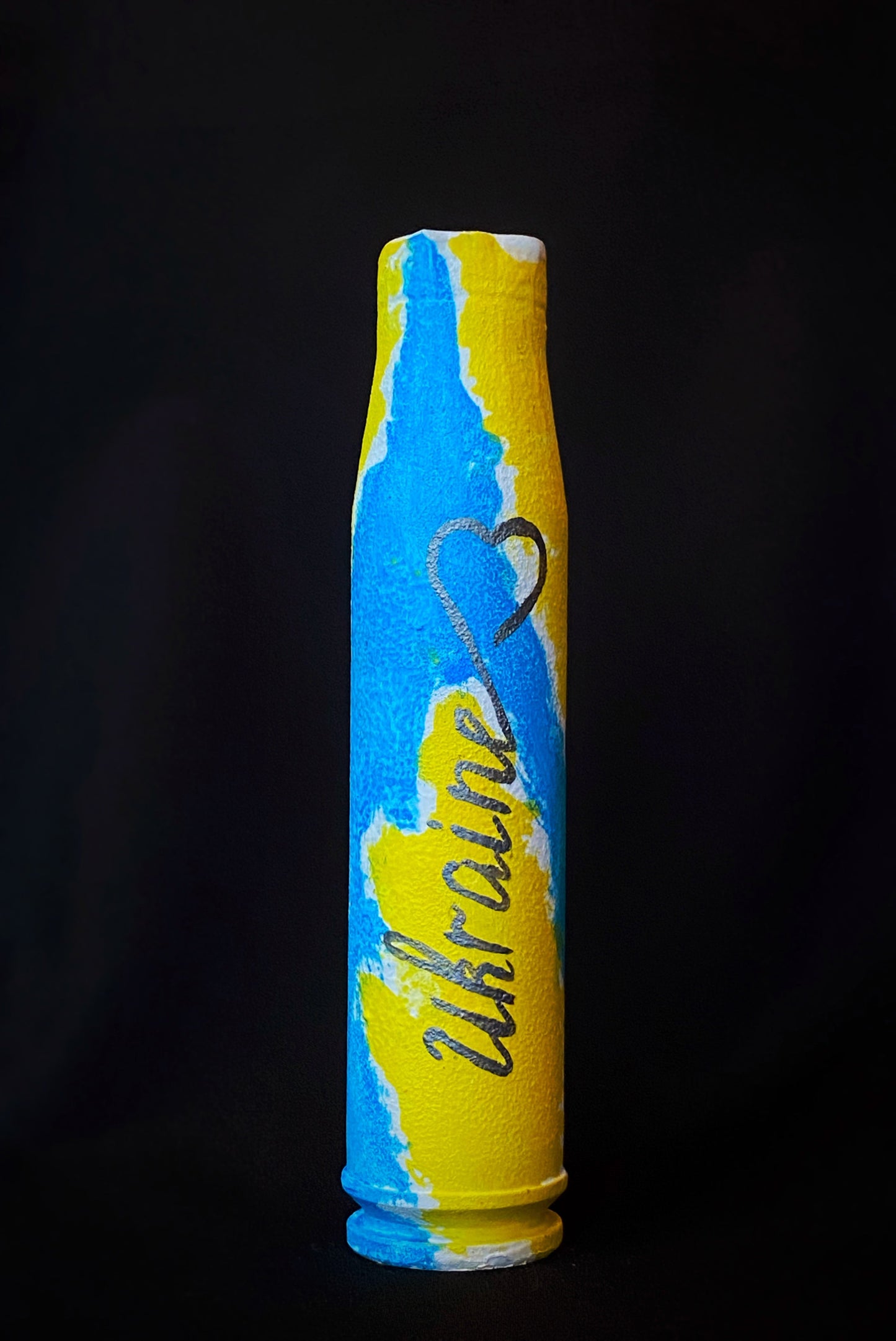 23mm shell painted with Ukrainian flag colors by Anna Huliaieva
