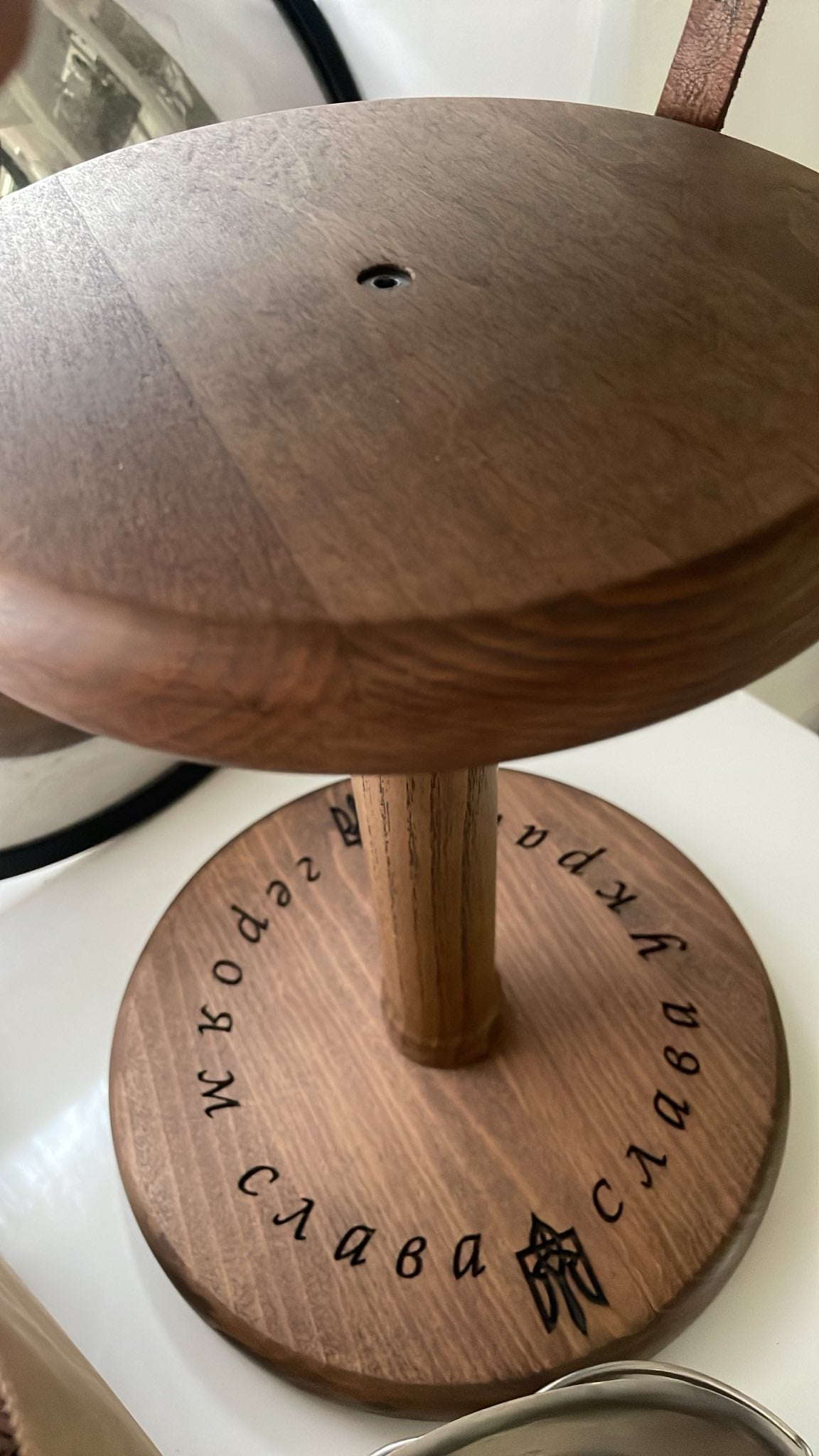 Wooden helmet stand designed by Vitaliy Shacun with natural wood finish