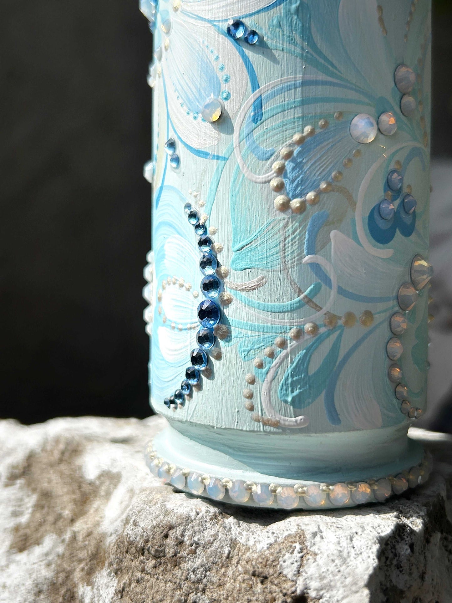 Hand-painted Gepard spent shell casing with light blue patterns and rhinestones by Ukrainian artist Anastasia