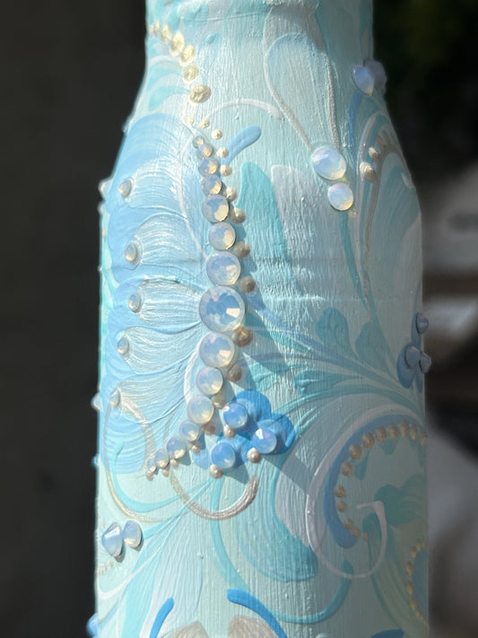 Hand-painted Gepard spent shell casing with blue patterns and rhinestones by Ukrainian artist Anastasia