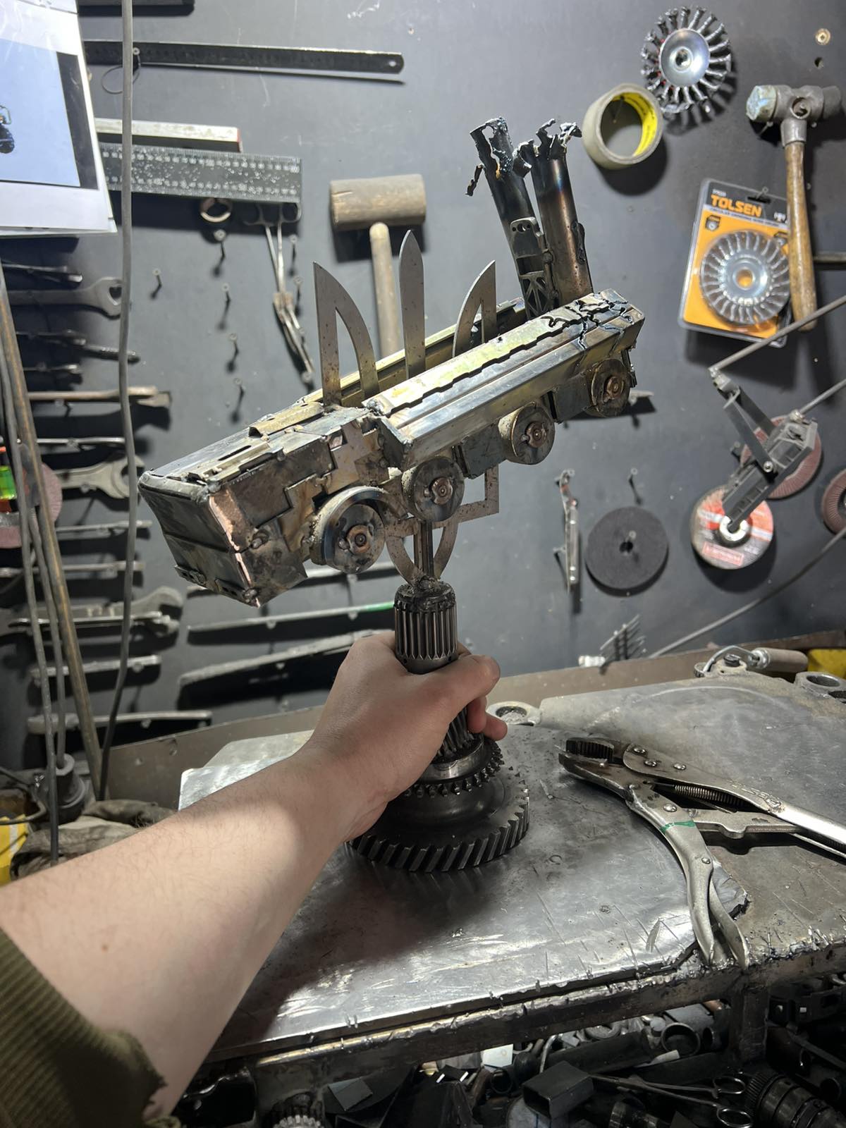 Destroyed K-300P Bastion-P missile launcher impaled on Tryzub emblem with KA-52 attack helicopter artwork