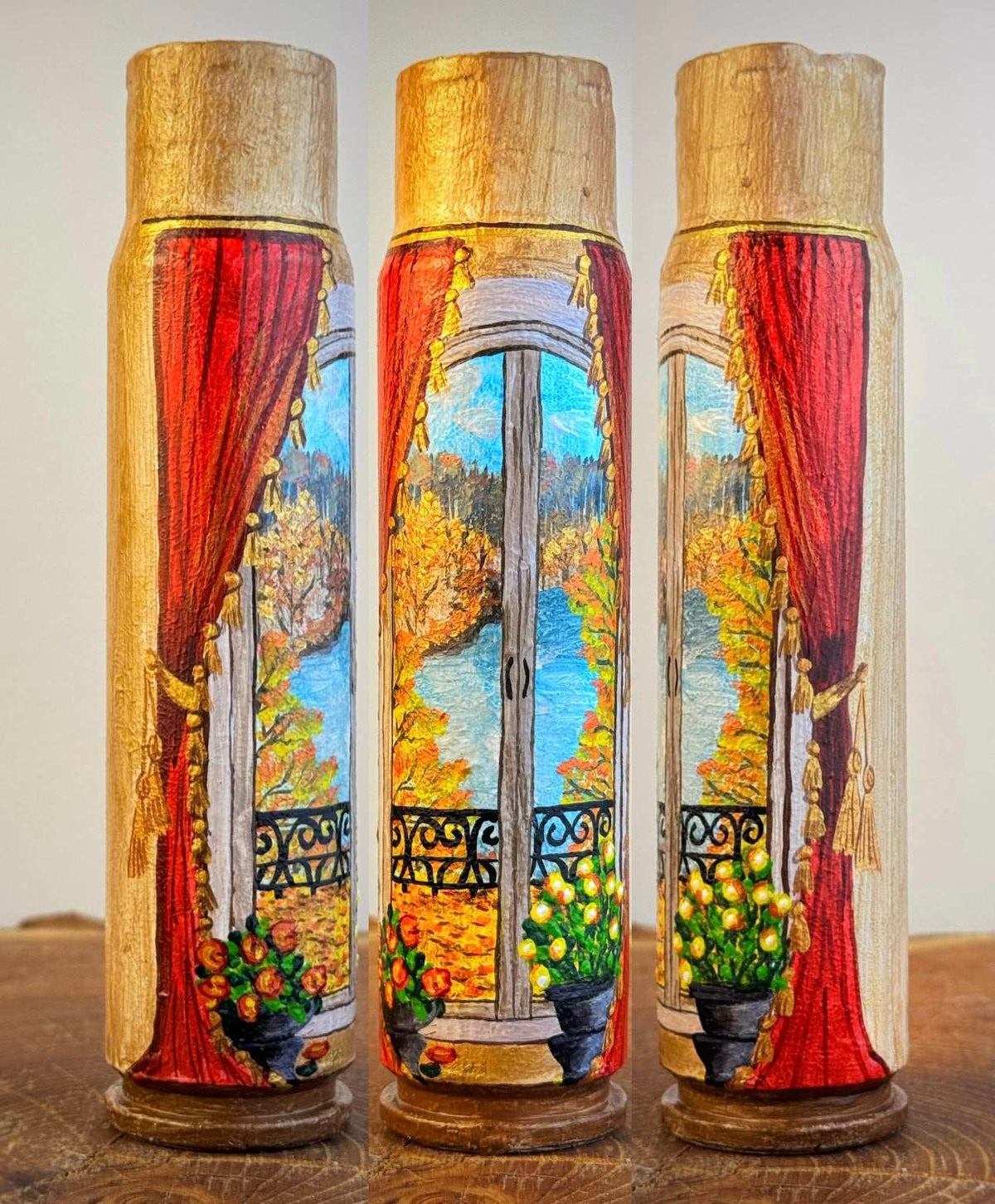 Painted shell in Germany with a vivid autumn window scene, red curtains, golden leaves, blue sky, and potted flowers