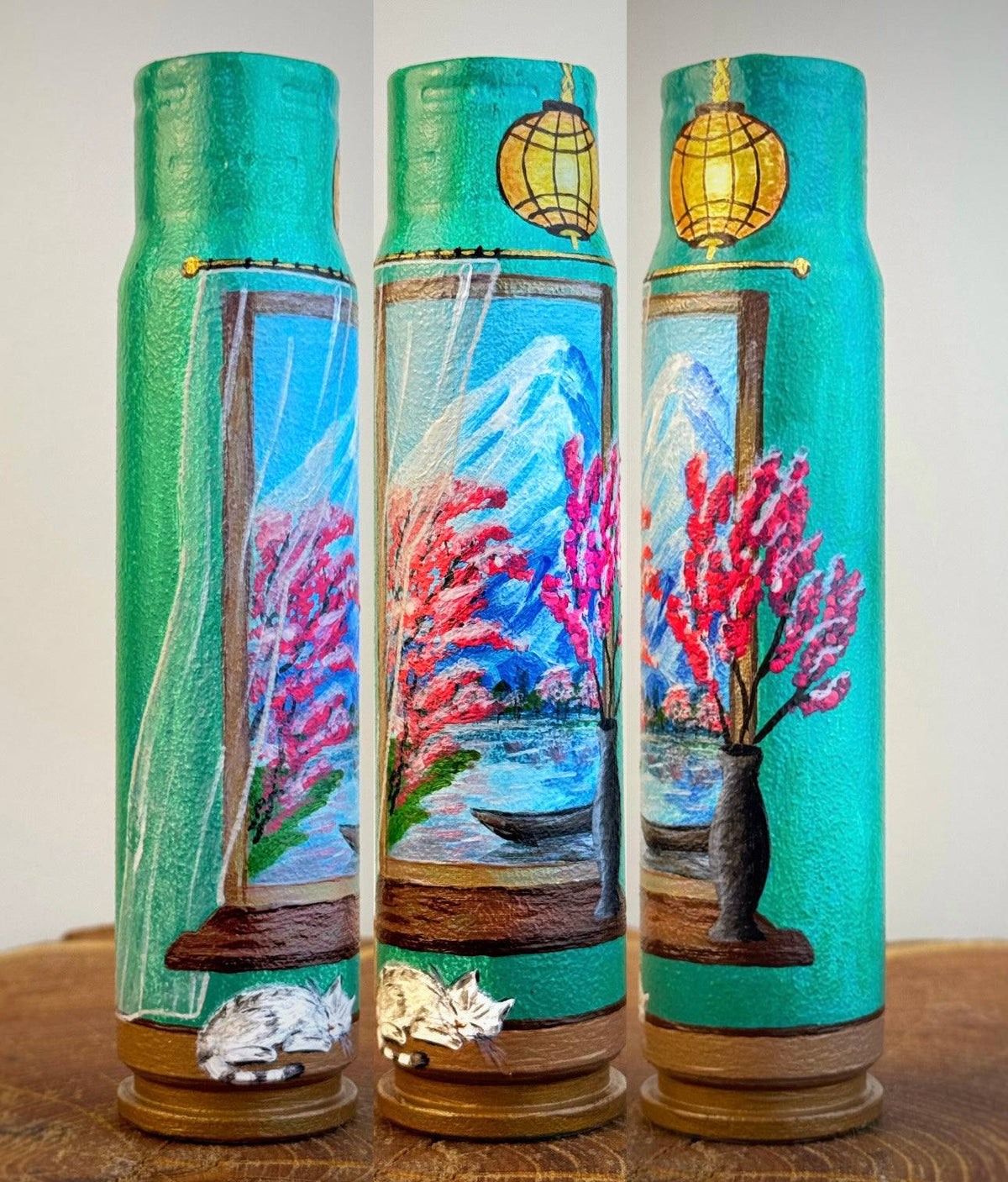 Painted shell souvenirs in turquoise with vibrant cherry blossoms framed as a window to Japan and a golden lantern, Germany
