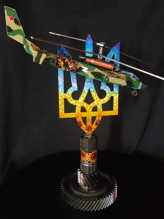 Destroyed KA-52 attack helicopter impaled on Tryzub sculpture by Hisoshi Art Studio
