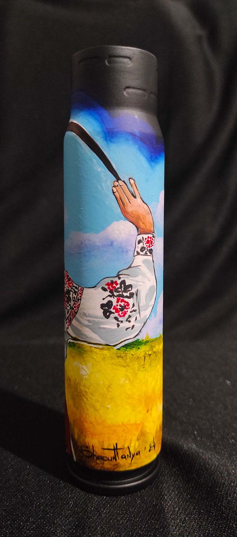 Ukrainian girl in traditional attire painted on 30mm shell by Tanya Shacun