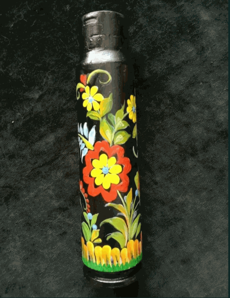 Painted 30mm shell, a Ukrainian reward system piece with a dark metal body covered in bright yellow, red and white flowers