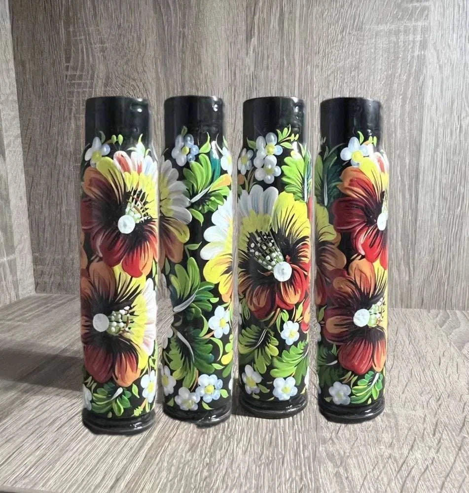 Painted 30 mm shell Ukrainian reward system, black cylindrical casing decorated with vibrant red, yellow and green floral patterns