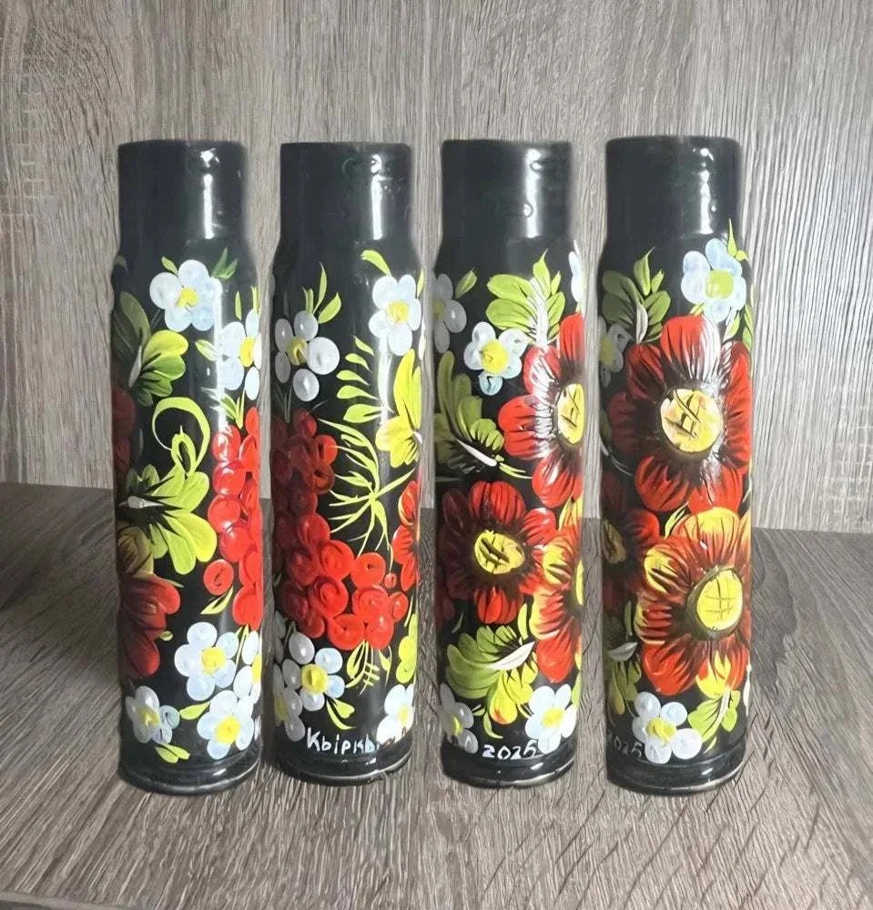 Ukrainian reward system: four black 30 mm shell casings hand-painted with red poppies, white flowers and green leaves