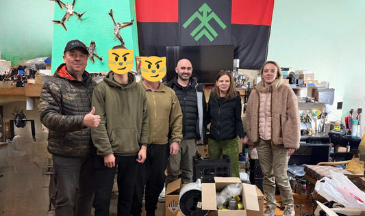 UAO volunteers unloading anti-drone camouflage nets for Ukrainian defenders in Combat Veteran News campaign