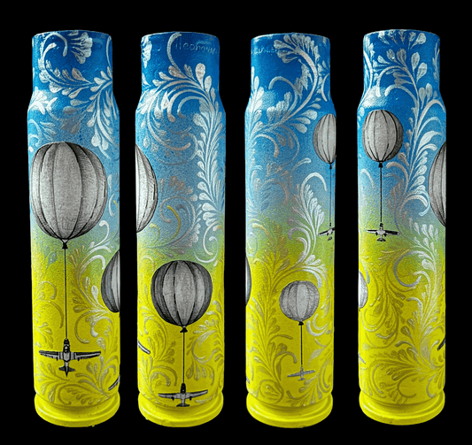 Painted 30mm spent shell featuring Ukrainian balloons launching hornet drones by artist Anastasia