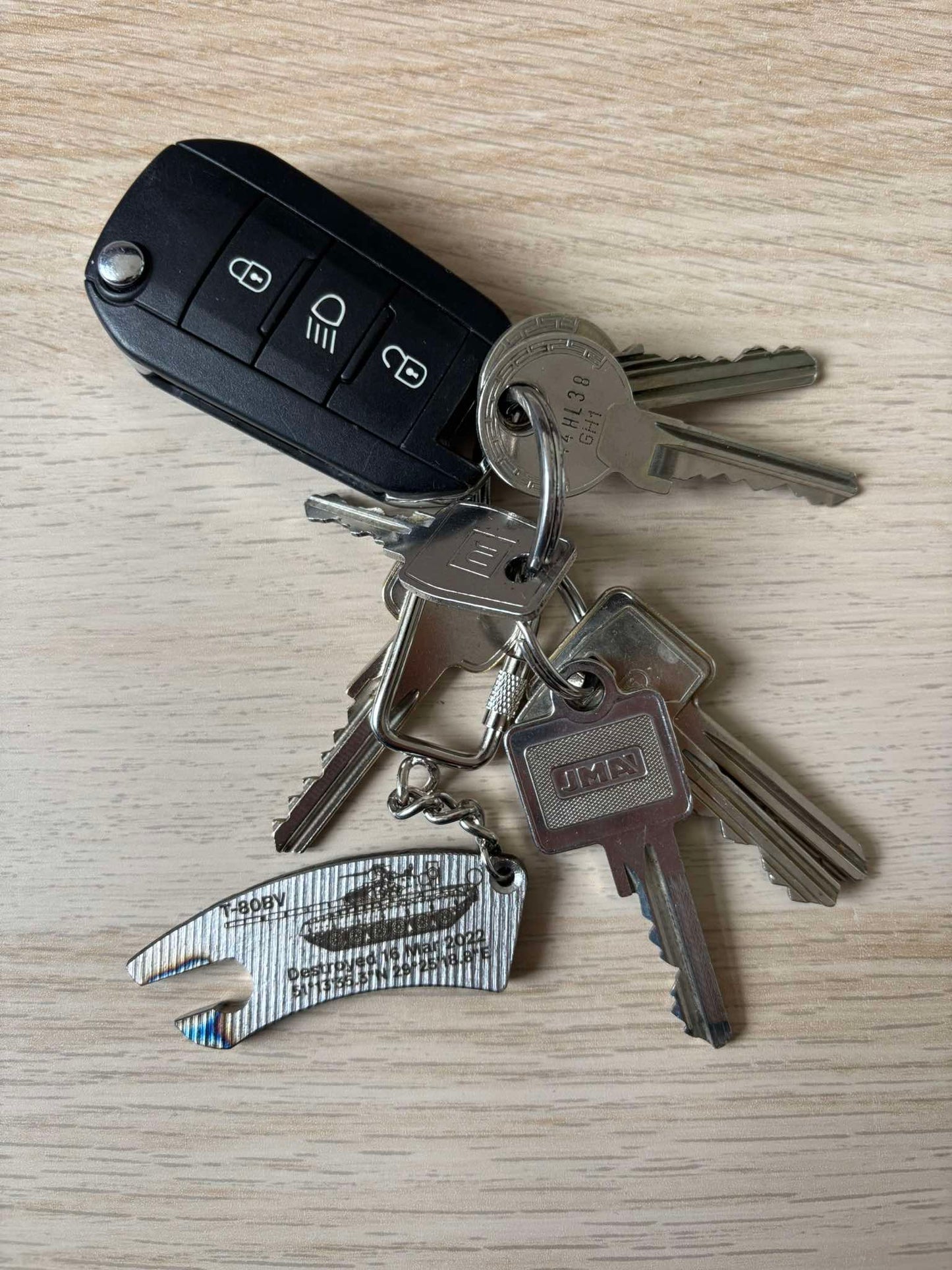 Engraved bottle-opener keychain made from a destroyed Russian T80BV tank (destroyed in 2022 near Poliske, north of Kyiv)