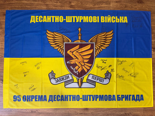 Flag 95th Air Assault Brigade with warriors' signatures supporting Ukrainian defenders and fundraising for equipment