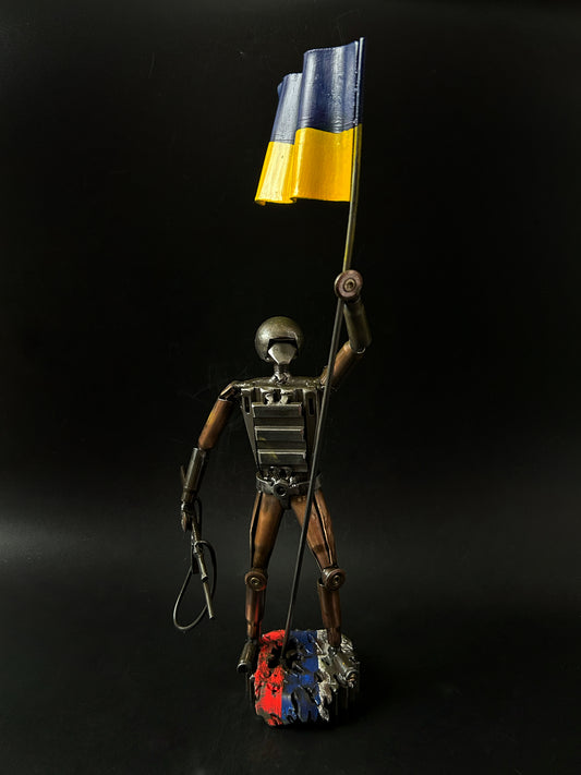 Ukrainian Soldier with Flag standing on russian rag (37cm).