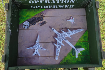 "Operation Spiderweb." painted ammunition box.
