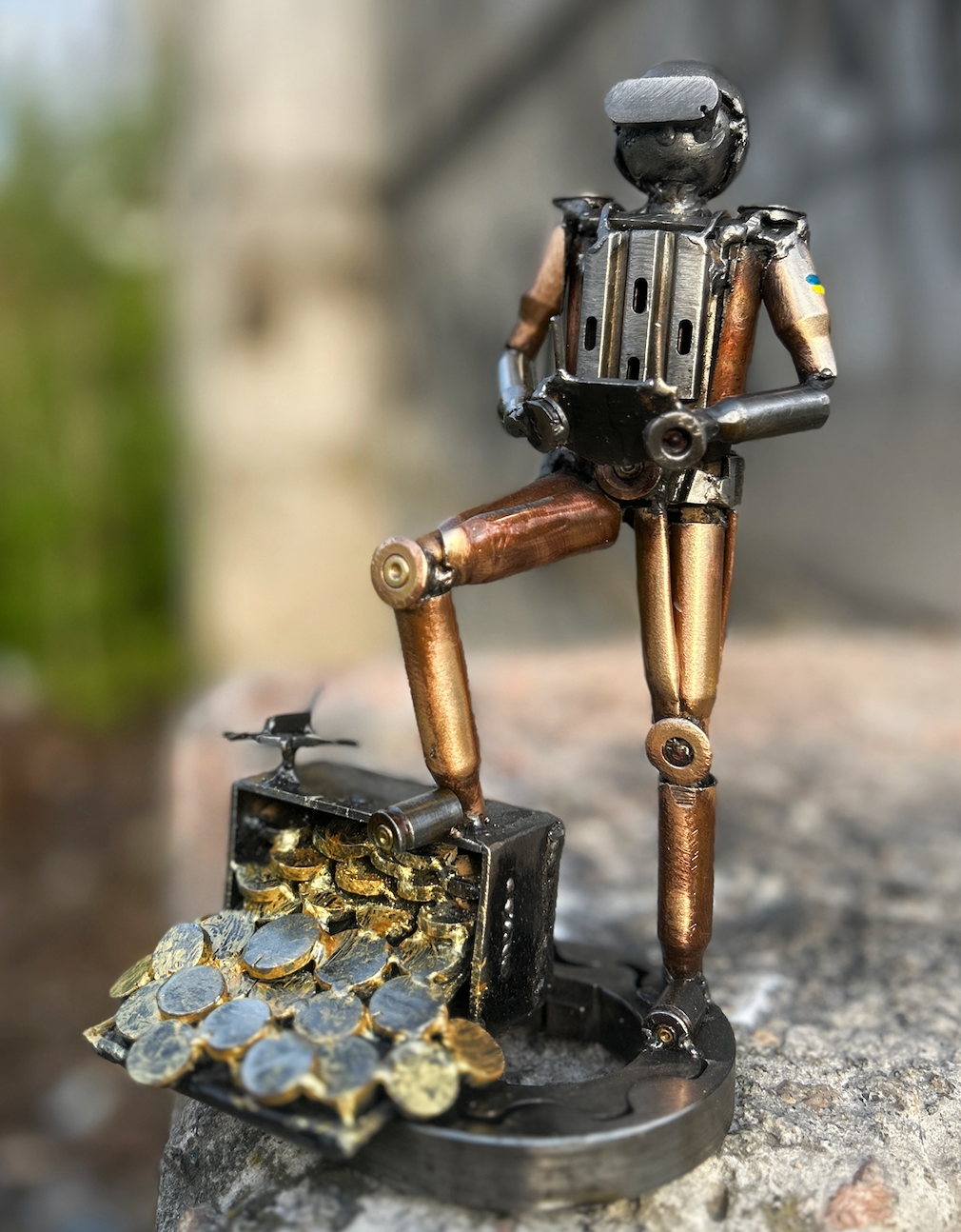 27cm sculpture of Ukrainian soldier with flag operating FPV drone, made from frontline shells