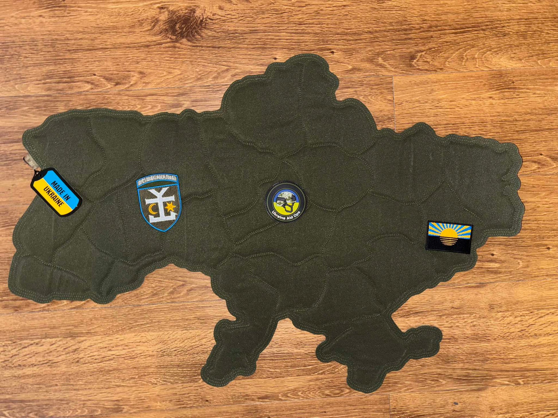A green patch map of Ukraine featuring three distinct patches.
