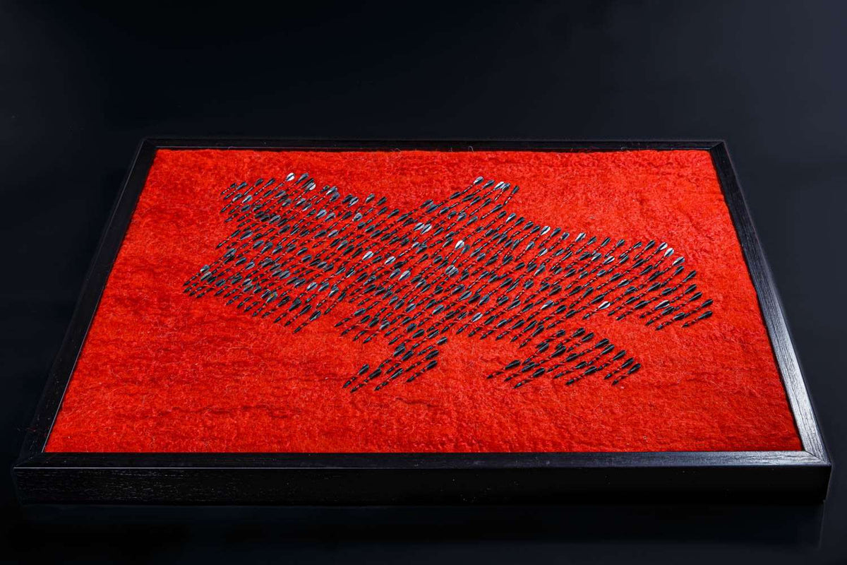 Air raid siren symbolized by wool map of Ukraine made from red wool and 300 fletchettes representing missile attacks