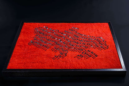 Air raid siren symbolized by wool map of Ukraine made from red wool and 300 fletchettes representing missile attacks