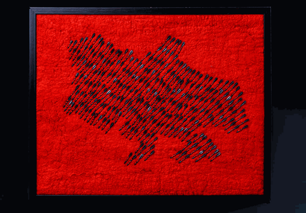 Air raid siren with wool map of Ukraine made from red wool and 300 fletchettes symbolizing destruction