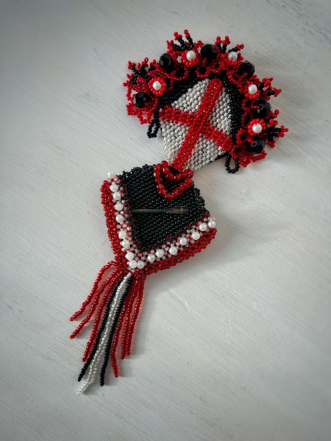 Brooch with flechette designed by Ukrainian artist Anna Huliaieva, featuring dart-shaped flechette recovered from Kyiv Oblast in 2022