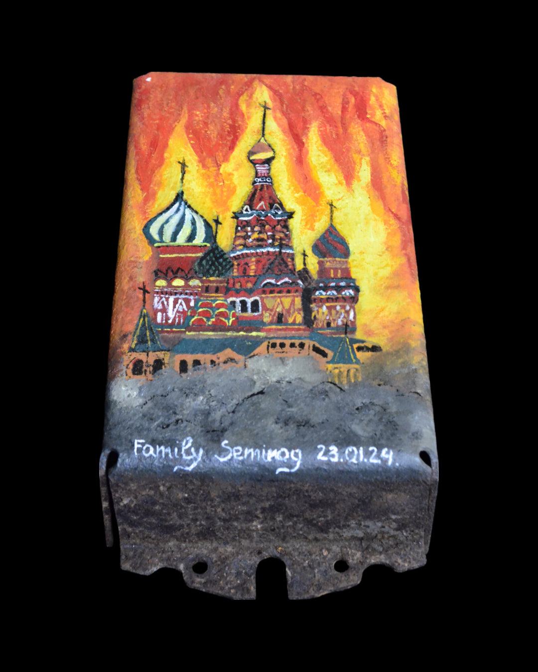 Piece of Burning Kremlin painted on turret from Ork's Cabbage Tank in Ukraine garden