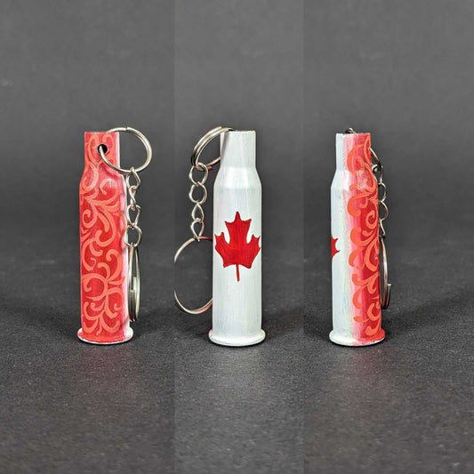 Small caliber keychain painted with Canadian flag colors representing Canada