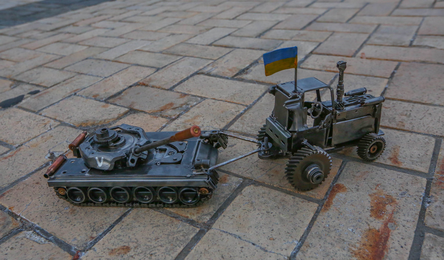 Trator ucraniano puxando um tanque russo