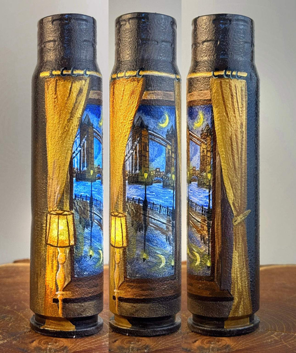 Germany painted shell casing featuring a golden curtain and lamp framing a blue nighttime Tower Bridge scene