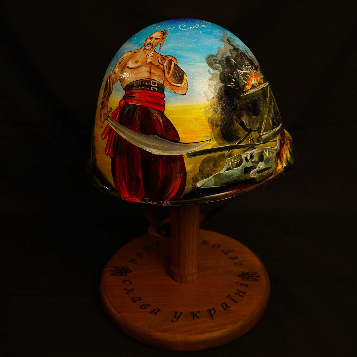 Enemy helmet with carved "Z" transformed into Indomitable Cossack Spirit artwork showing Ukrainian soldier and Cossack