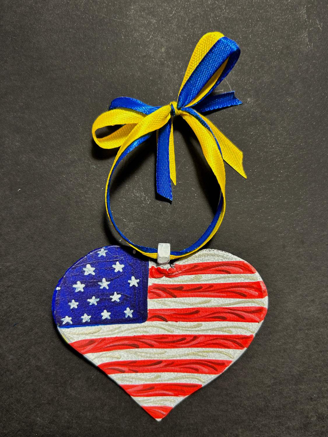 Iron Heart ornament painted in American and Ukrainian flag colors made from 122mm Grad rocket