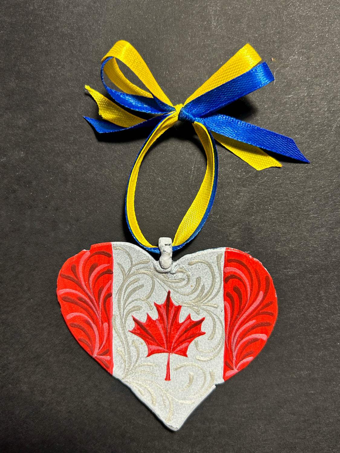 Iron Heart ornament painted with Canadian and Ukrainian flags made from 122mm grad rocket