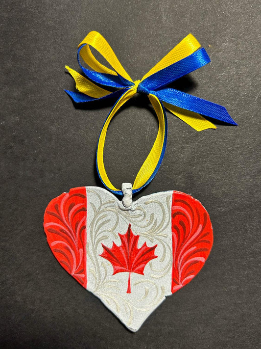 Iron Heart ornament painted with Canadian and Ukrainian flags made from 122mm grad rocket
