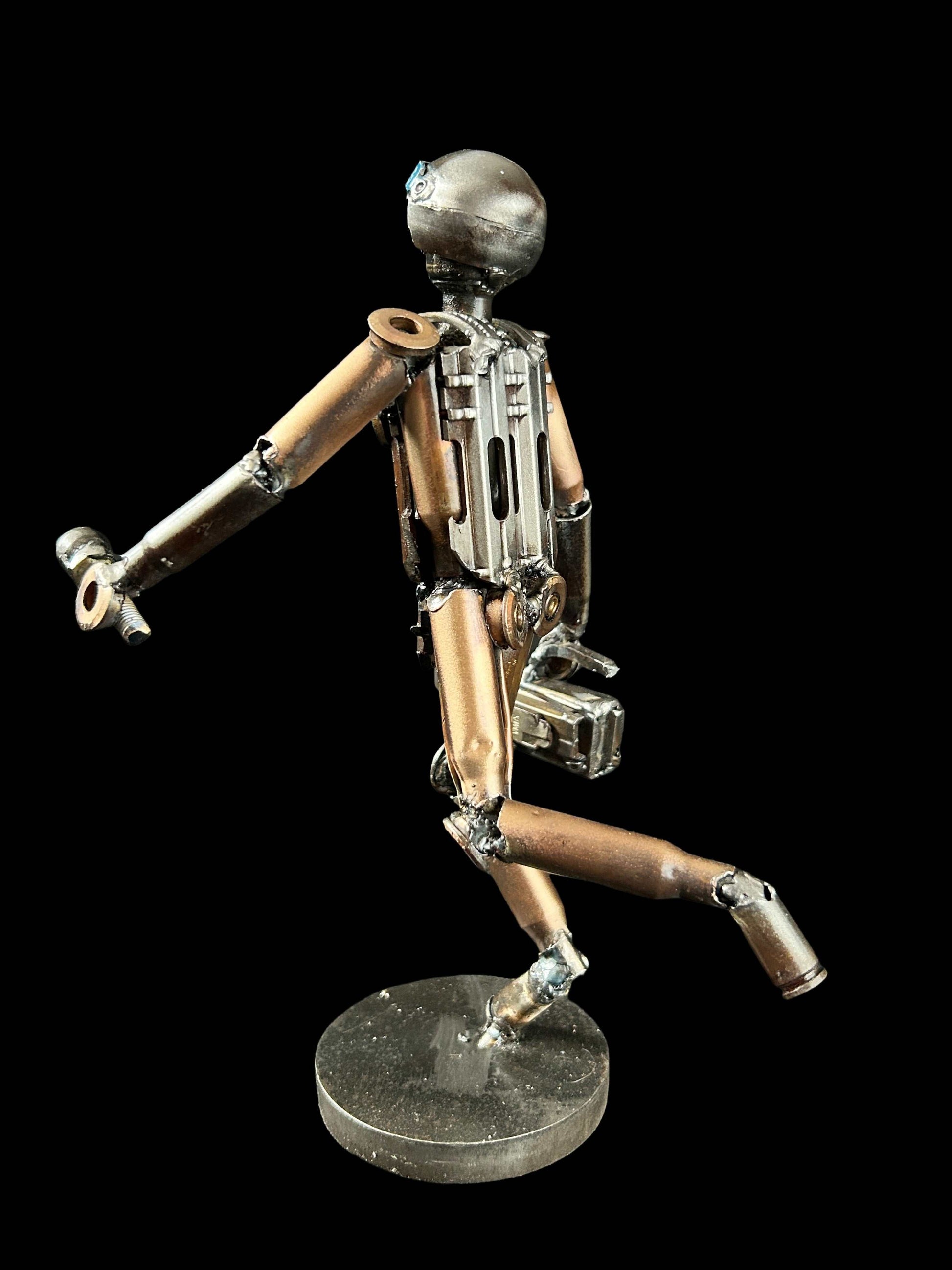Sculpture of journalist created from small caliber shells by Lenny Pridatko, designed by Hisoshi Art Studio and painted by Anastasia Leonova.