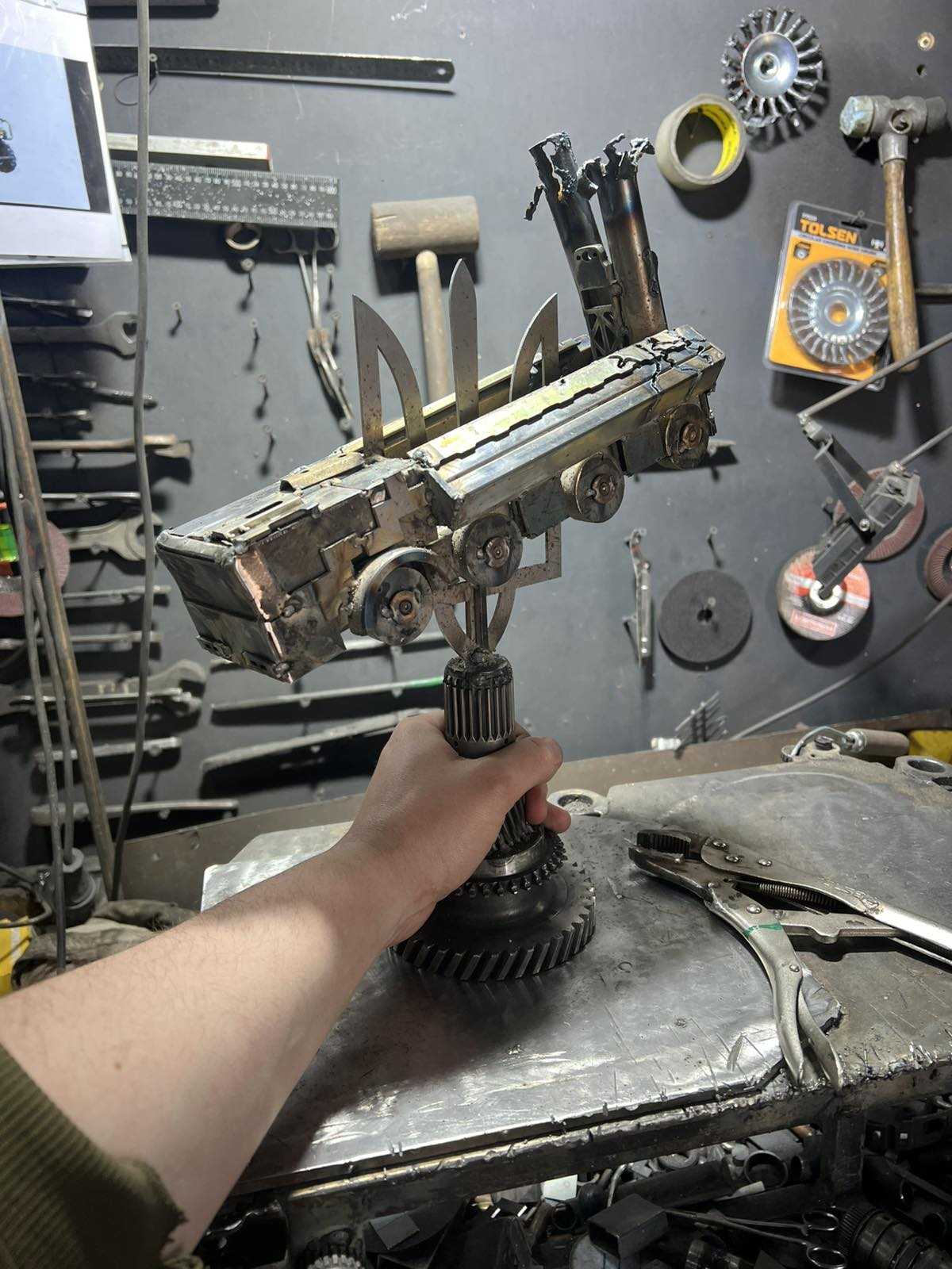 Destroyed K-300P Bastion-P missile launcher impaled on Tryzub emblem with KA-52 attack helicopter artwork
