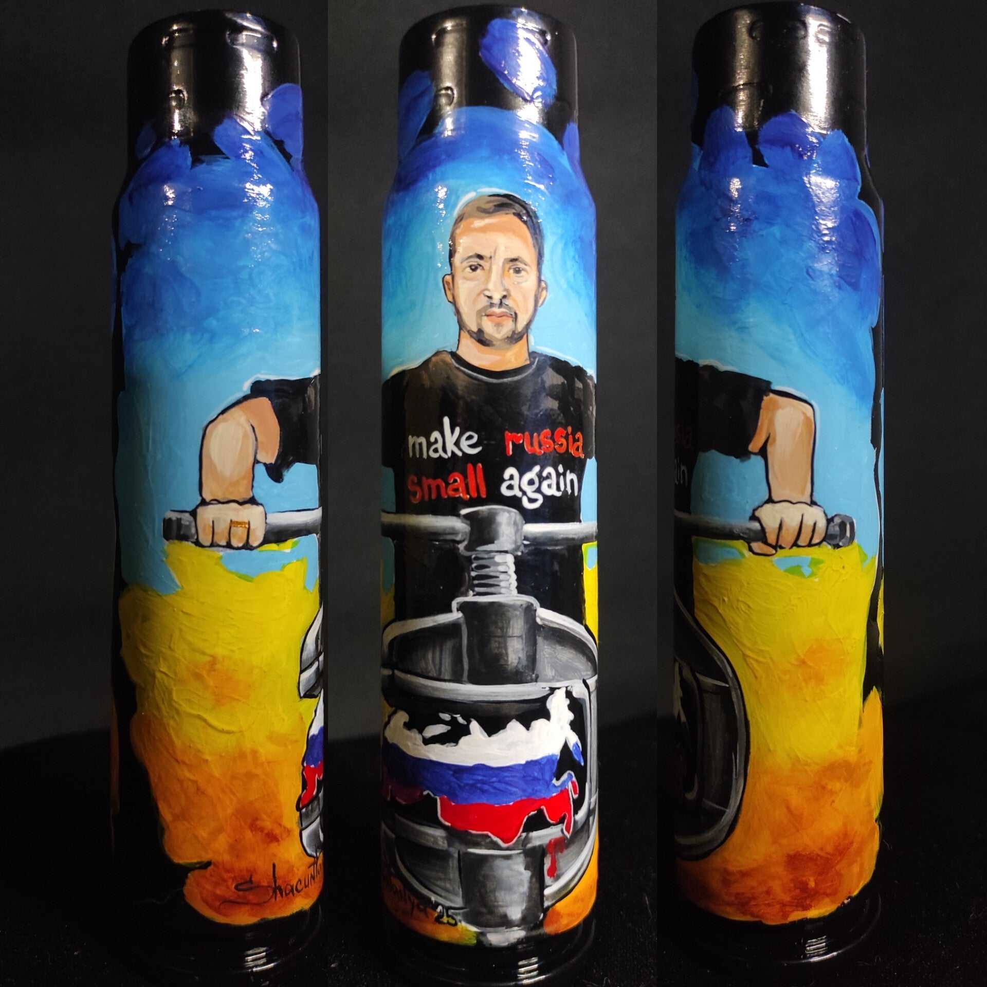 President Zelensky with "Make Russia small again" text painted on 30mm shell by artist Tetana