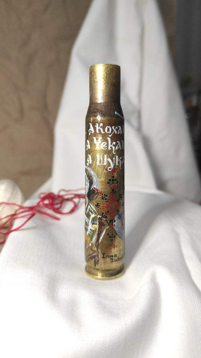 Mother waiting for missing son embroidered on small caliber shell artwork by Inna Zubok