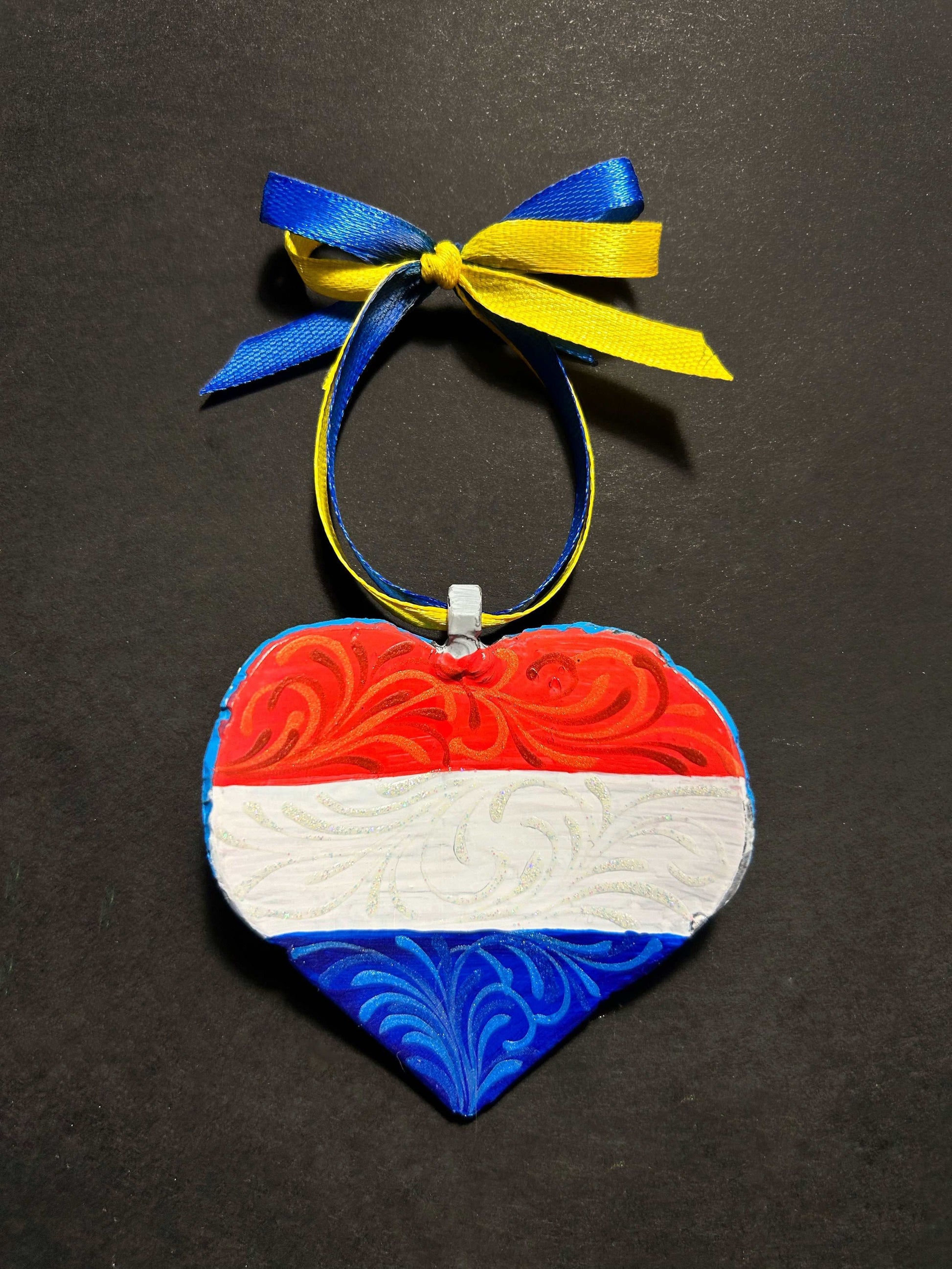 Iron Heart ornament painted with Dutch and Ukrainian flags made from 122mm grad rocket