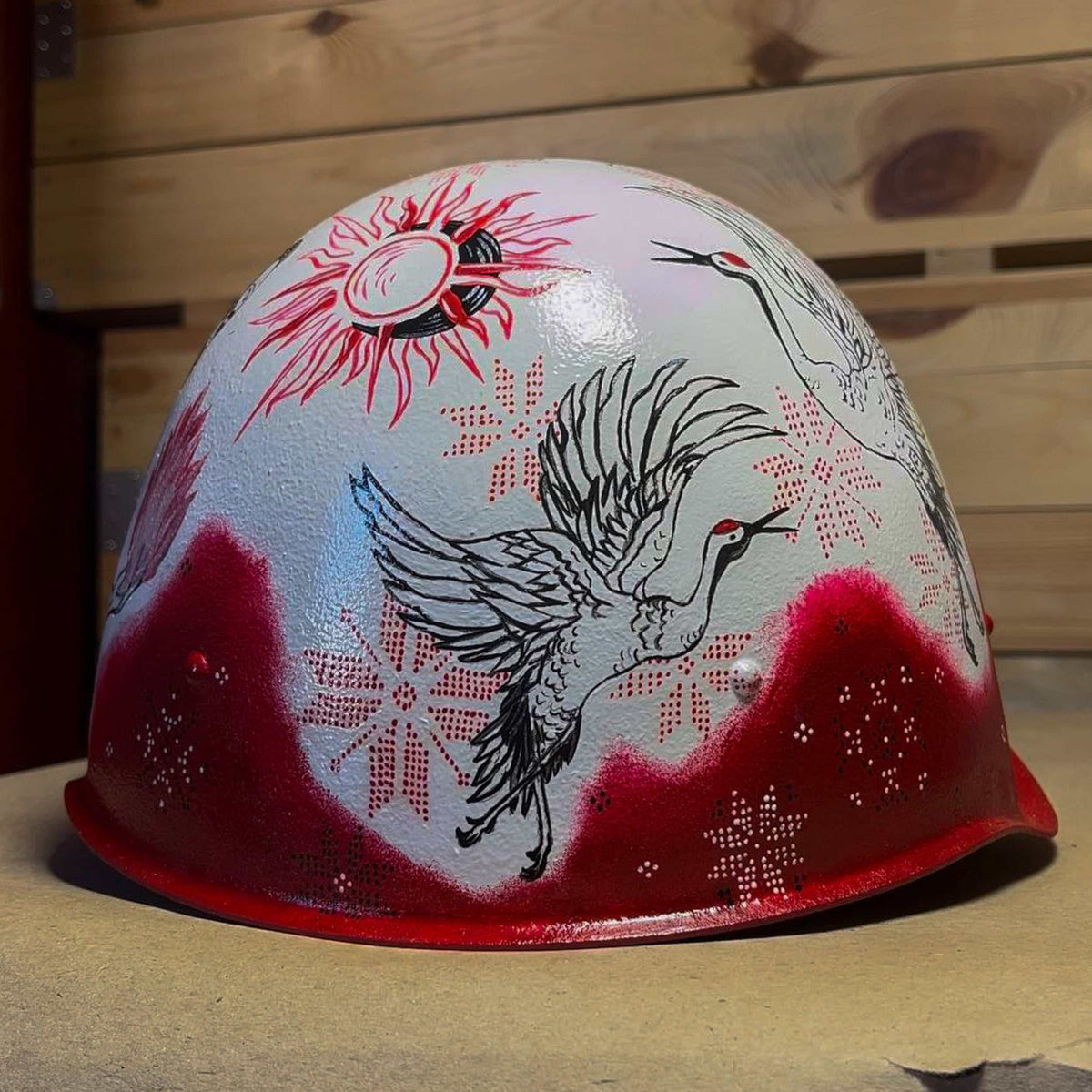 Occupant's helmet with multiple drawings symbolizing Ukrainian resistance and Victory Gallery fundraiser artifacts