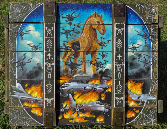 Operation Spiderweb painted ammunition box by Tanya Shacun with a cat nearby