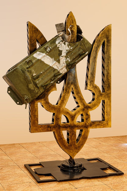 Part of Russian Kamaz truck impaled on large painted Tryzub sculpture