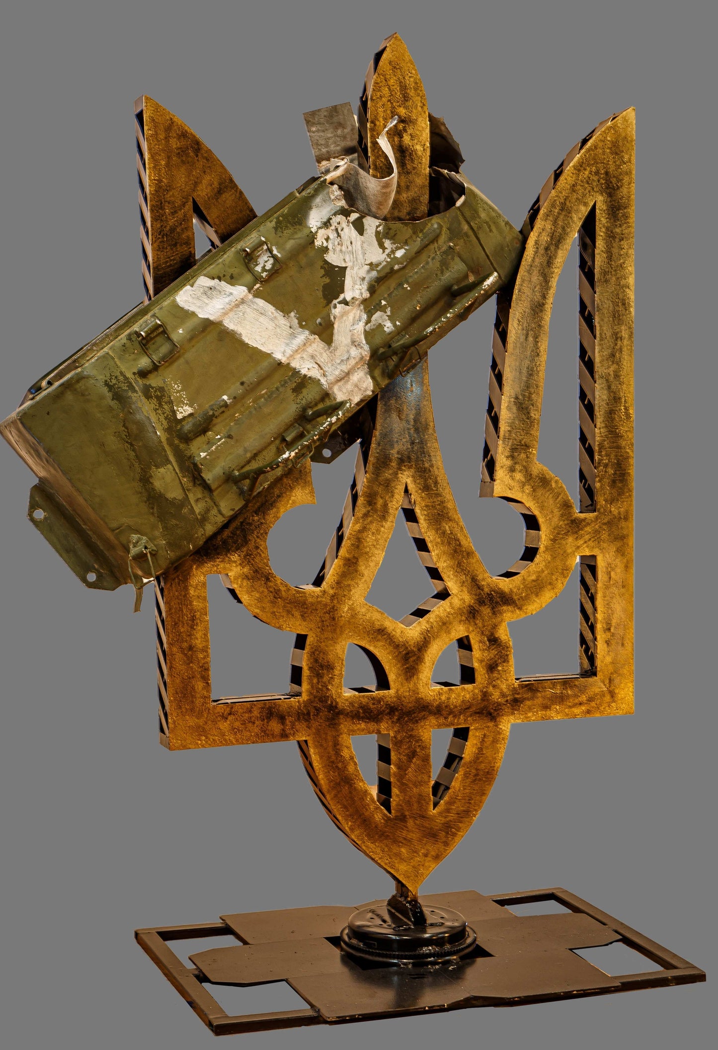 Part of destroyed Russian Kamaz truck with painted "V" impaled on large Tryzub sculpture