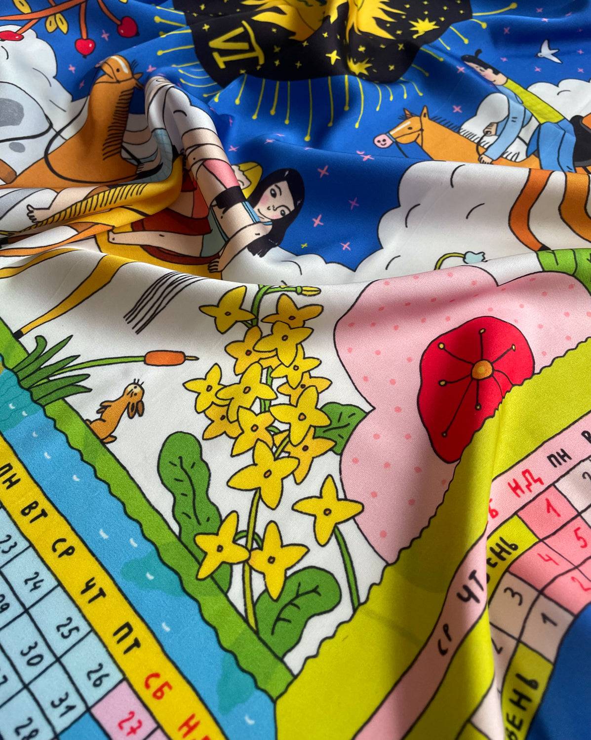 Scarf designed in Ukraine featuring a 70x70cm silk calendar with horse and cosmic motifs