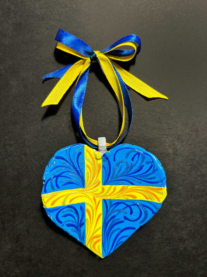Iron Heart ornament painted with Swedish and Ukrainian flags made from 122mm grad rocket