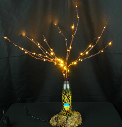 Tree of light sculpture growing from a spent Gepard shell near a European 220V outlet designed by Tanya Shacun