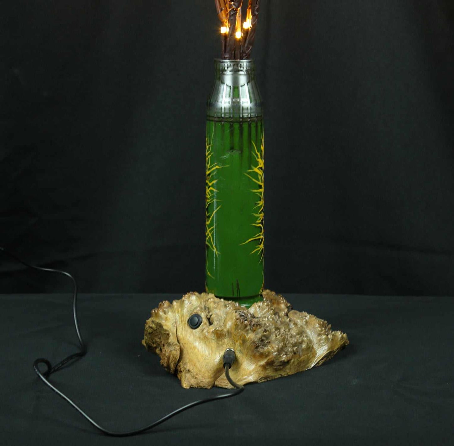 Tree of light sculpture growing from spent Gepard shell near European outlet designed by Tanya Shacun