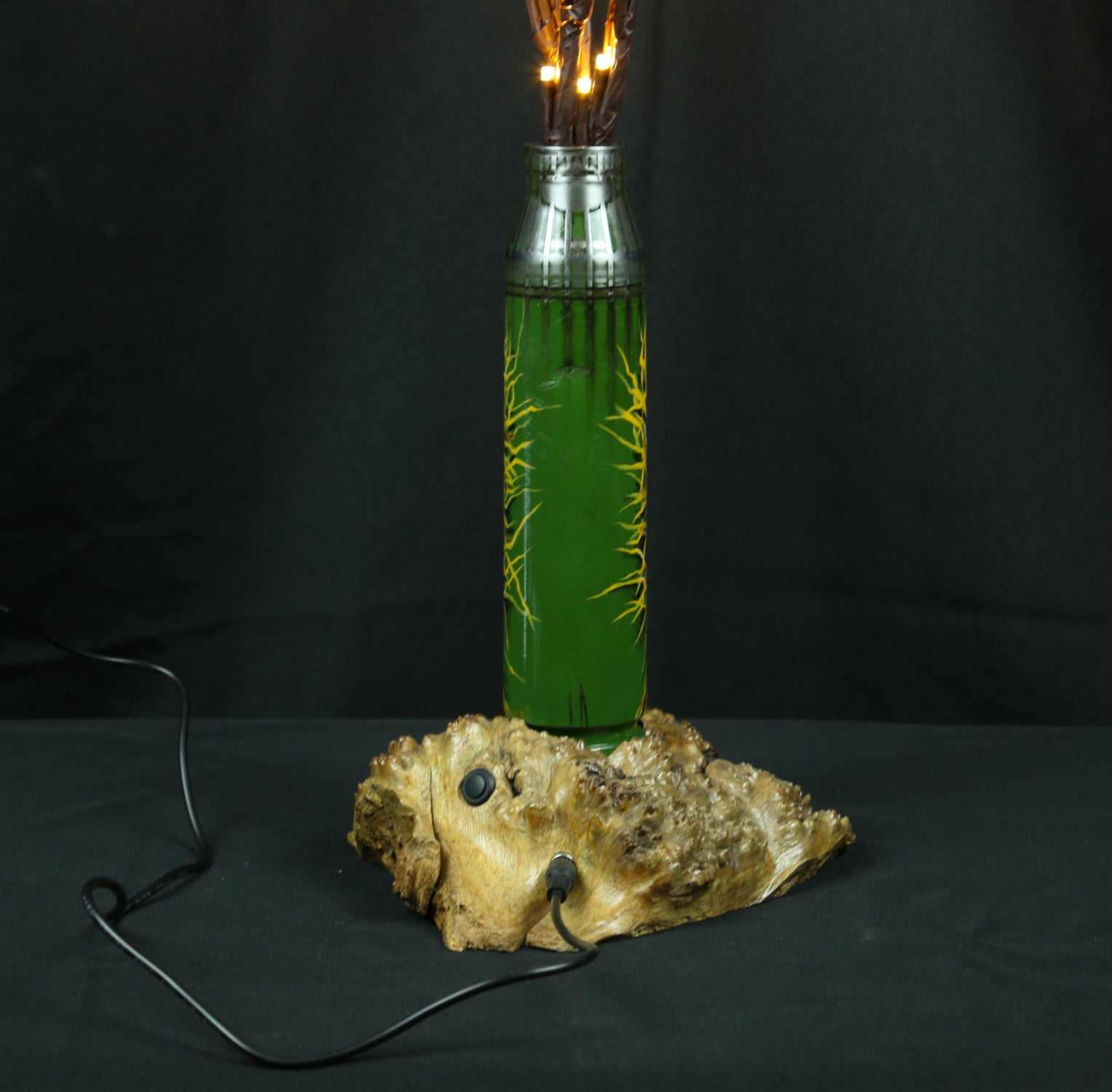 Tree of light sculpture growing from spent Gepard shell near European outlet designed by Tanya Shacun