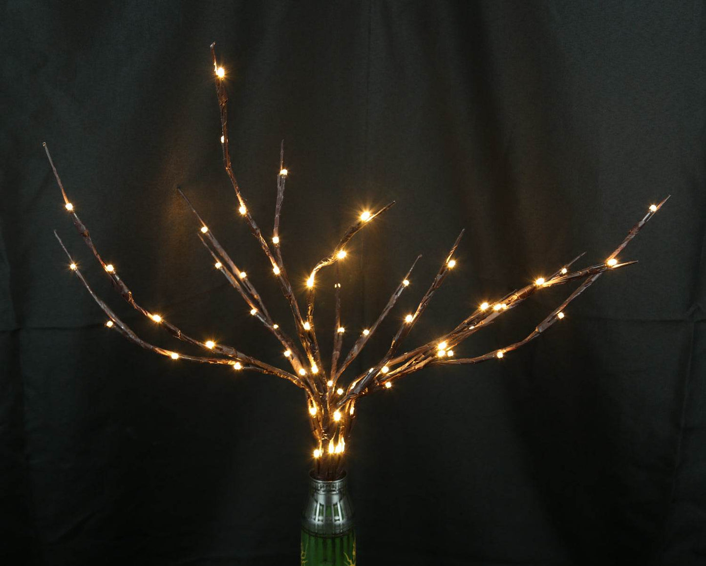 Tree of light sculpture growing from spent Gepard shell near European 220V outlet designed by Tanya Shacun