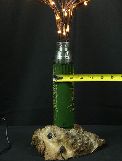 Tree of light sculpture growing from a spent Gepard shell near a European 220V outlet designed by Tanya Shacun