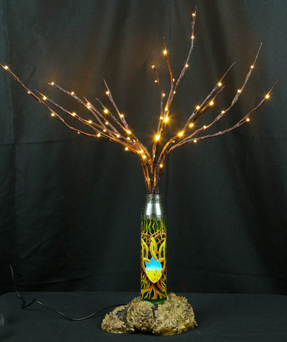 Tree of light sculpture growing from spent Gepard shell next to European 220V outlet designed by Tanya Shacun