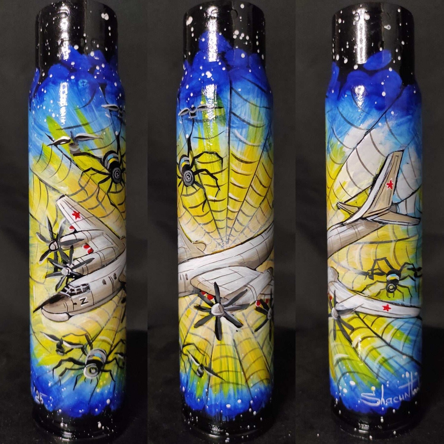 TU-95 aircraft trapped in a Ukrainian spiderweb painted on a 30mm shell by Tanya Shacun
